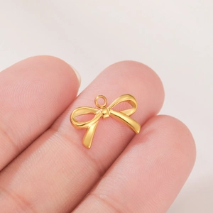 Minimalist gold stainless steel bow pendant for DIY jewelry on fingertips