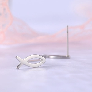 Macro shot of silver minimalist Jesus fish stud earrings with polished hollow design