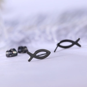 Macro detail of black Ichthys fish stud earrings in polished stainless steel