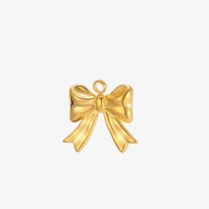 Detailed view of a polished gold bow pendant with top loop for DIY jewelry crafting