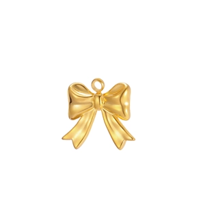 Close-up of polished gold bow pendant with smooth mirror finish and integrated ring