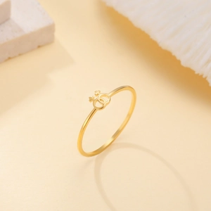 Close-up of gold plated stainless steel ring featuring interlocking double Venus symbols