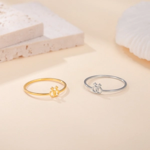 Minimalist 18K gold and silver stainless steel rings with interlocking female symbols
