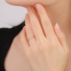 Detail of a minimalist silver stainless steel ring with double female symbols on model