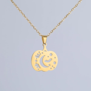 Macro shot of 18K gold plated hollow pumpkin pendant with moon and bat details