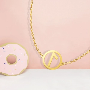 Detail of 18K gold stainless steel necklace with circular Viking rune pendant detail