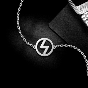 Macro detail of silver stainless steel Viking Sig rune charm on polished cross chain