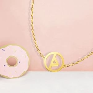 Macro shot of 18K gold plated stainless steel letter A pendant on a thin O-chain