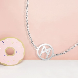 Detailed macro view of a silver Viking rune necklace with geometric cutout pendant