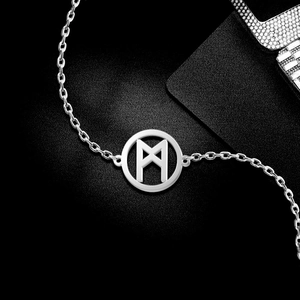 Detail of silver Viking Rune circle pendant on a stainless steel cross chain