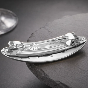 Detail of the silver alloy spring clip mechanism on the crescent cat hair jewelry