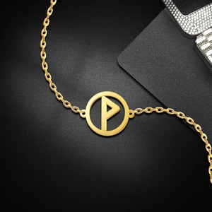 Close-up of golden stainless steel chain with a circular P-letter pendant on black background