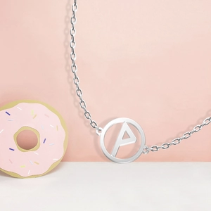 Silver stainless steel necklace featuring a round hollow pendant with the letter P detail