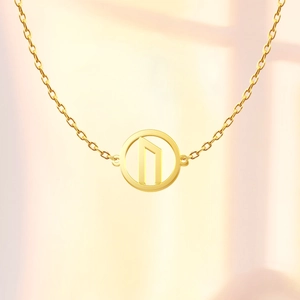 Detailed close-up of 18K gold stainless steel O-chain and Runic Uruz pendant