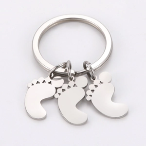 Polished stainless steel keychain with three cute baby footprint pendants in silver