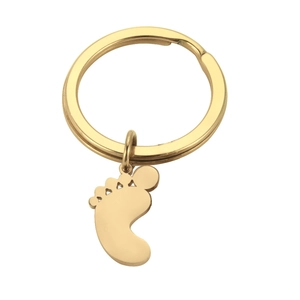 Detailed view of a golden stainless steel keychain with a cute footprint shaped pendant