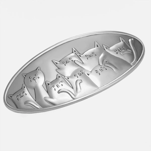 Macro view of oval silver alloy hair clip featuring detailed 3D embossed cat motifs