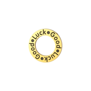 Macro shot of gold stainless steel charm featuring black Good Luck engraving for DIY jewelry