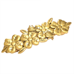 Golden flower hair clip with ladybug relief details on a clean white background