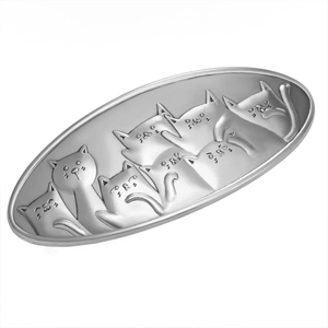 Macro detail of oval silver alloy cat hair clip with textured matte metal relief