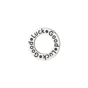 Close-up of silver stainless steel charm with black Good Luck engraving and dot details