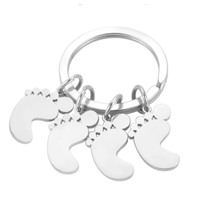 Polished silver stainless steel keychain with four cute baby feet charms on a ring