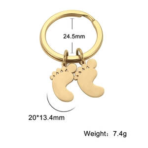 Detailed view of gold foot charms keychain with dimensions 24.5mm ring and 20mm pendants