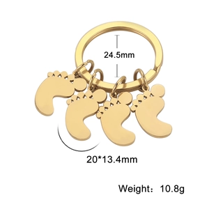Detail showing dimensions of golden footprint charms on a stainless steel keychain