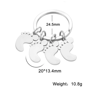 Polished silver stainless steel keychain featuring four cute baby footprint pendants