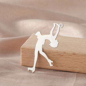 Detail of silver roller skater silhouette pendant on champagne silk with wood accent