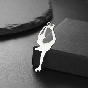 Polished silver skater pendant on a dark jewelry box with mirror finish detail