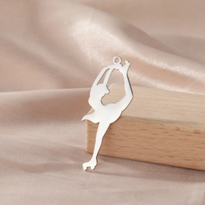 Detailed view of silver polished ice skater pendant on warm champagne silk background