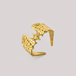 Detailed view of 18K gold plated gothic bat wing ring with hammered texture finish