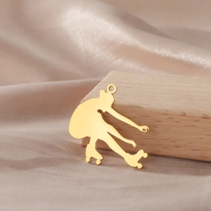 Macro view of 18K gold plated roller skater pendant with polished mirror finish