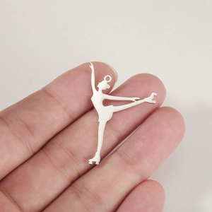 Close-up of silver stainless steel ballet dancer pendant with roller skate detail
