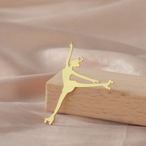 Detailed view of polished 18K gold plated roller skater pendant on elegant pink silk