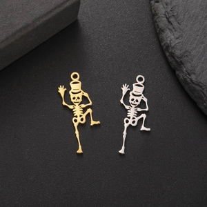 Macro view of gold and silver dancing skeleton pendants for DIY jewelry making