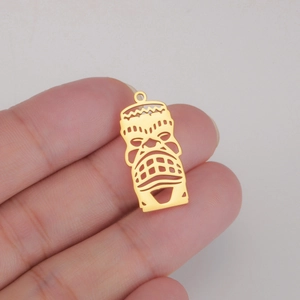 Close-up of a 18K gold plated titanium steel hollow clown mask pendant held in hand