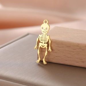 Detailed close-up of a 18K gold-plated hollow skeleton pendant for Halloween DIY jewelry