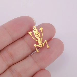 Macro detail of a 18K gold plated hollow skull pendant with top hat for DIY jewelry making