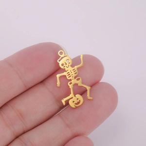 Detail view of 18K gold plated hollow skull pendant with pumpkin and Christmas hat