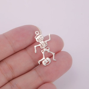 Detailed view of silver skeleton and pumpkin pendant for DIY Halloween jewelry making