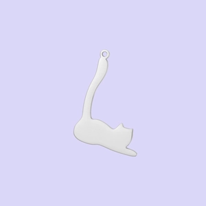 Close-up of a polished stainless steel cat pendant in stretching pose on purple background