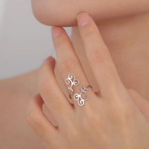 Polished silver stainless steel ring with elegant hollow vine pattern on a female hand