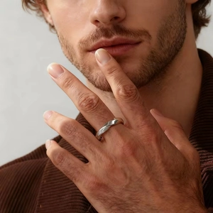 Polished silver stainless steel Mobius twist ring for men in a minimalist geometric style