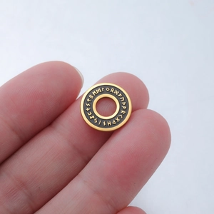 Golden stainless steel circular rune pendant with black enamel and hollow center charm