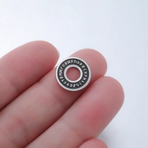 Detailed macro view of 15mm stainless steel Norse Rune beads for DIY jewelry making