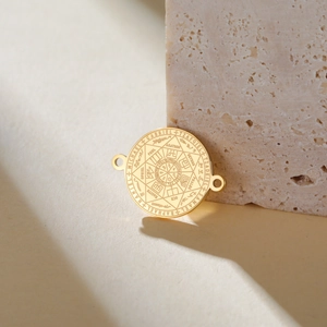 Macro detail of golden Seven Archangels seal pendant with dual holes for DIY jewelry making