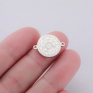Macro shot of a silver titanium steel Seven Archangels compass pendant with dual loops