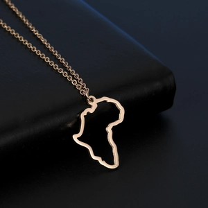Rose gold Africa map pendant necklace on black leather texture for elegant jewelry gift